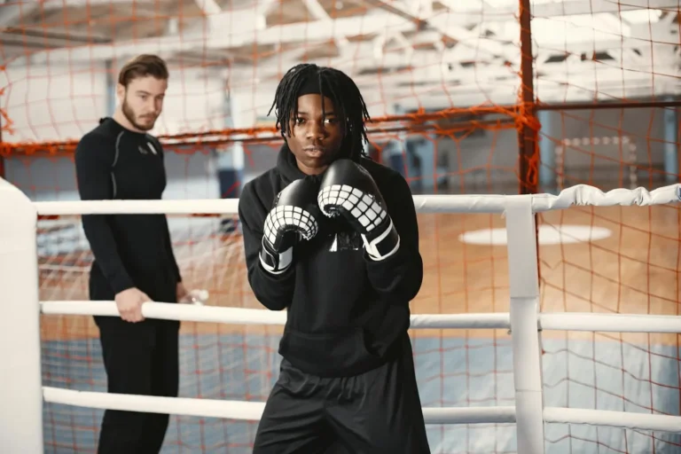 Young athletes training in a boxing ring, focusing on combat sports skills.